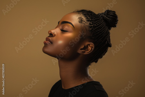 A close up of a black woman's face with her eyes closed looking to a side © MagnusCort