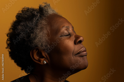 A close up of a black woman's face with her eyes closed looking to a side