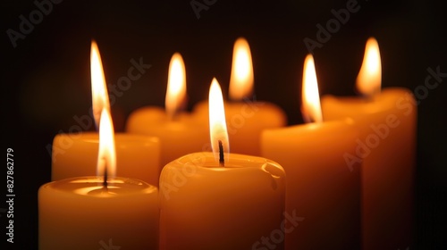 Bright candles glowing against a dark backdrop