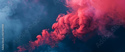 Layers of vibrant red smoke billowing against a backdrop of deep blue, creating a dynamic contrast of light and shadow. photo