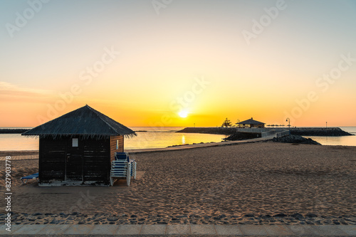 Obraz na płótnie Dawn breaks over La Guirra Beach, Caleta de Fuste, casting a peaceful golden glow across the tranquil waters of Fuerteventura w salonie