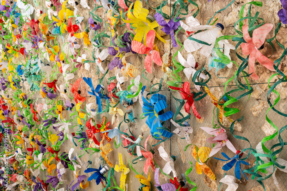 Fototapeta premium Flower wall decoration with plastic bottles made from plastic waste. Concept: Waste recycling and environmental protection