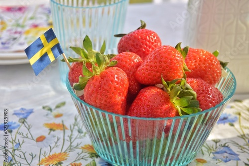 Strawberries with the Swedish flag on the table. Midsommar holiday
