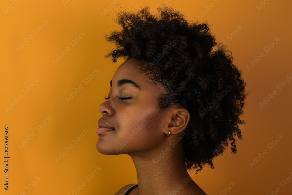 A close up of a black woman's face with her eyes closed looking to a side A close up of a black woman's face with her eyes closed looking to a side