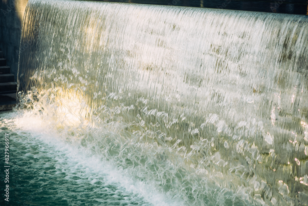 water flowing from the fountain in the city park water flowing from the fountain in the city park