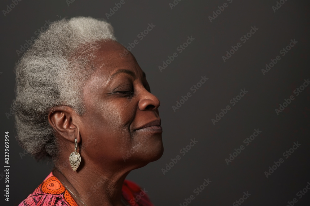 Fototapeta premium A close up of a black woman's face with her eyes closed looking to a side
