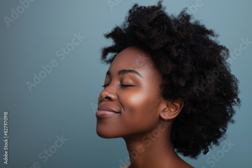 A close up of a black woman's face with her eyes closed looking to a side