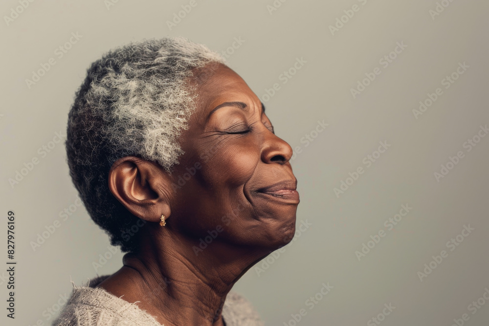 A close up of a black woman's face with her eyes closed looking to a side A close up of a black woman's face with her eyes closed looking to a side
