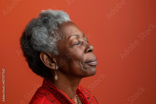 A close up of a black woman's face with her eyes closed looking to a side