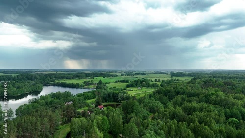 Aerial View of Countryside Landscape with Storm Clouds and Rain Showers Over Green Fields and River, Alanta, Lithuania. photo