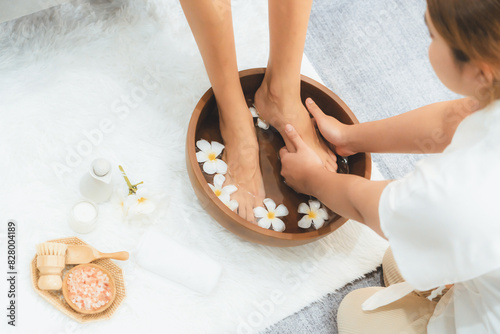 Bilde på lerret Woman indulges in blissful foot massage at luxurious spa salon while masseur give reflexology therapy in gentle day light ambiance resort or hotel foot spa