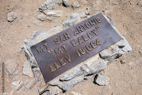 Old metal Mt Baldy and Mt San Antonio summit sign.  Elevation 10,064 feet.  The highest peak in the San Gabriel Mountains in Southern California.  