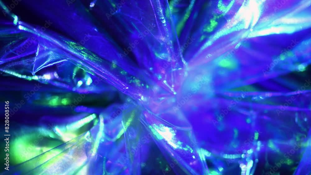 Slow moving constantly flowing eerie abstract shiny plastic blue green purple star-like background Slow moving constantly flowing eerie abstract shiny plastic blue green purple star-like background