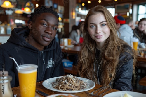 Two friends enjoying a meal together at a cozy restaurant  with a plate of pasta and drinks on the table  ambient lighting  and a lively background