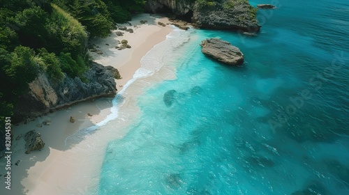 An aerial view of a coastal beach with rocks  surrounded by electric blue water. Natural landscape with oceanic and fluvial landforms  including reefs and lakes AIG50