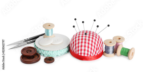 Pincushion, pins and other sewing tools isolated on white
