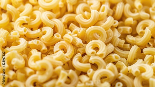 Close up of uncooked macaroni noodles with a textured background