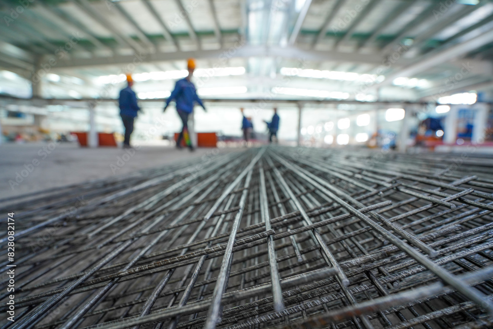 Workers are moving metal mesh in the workshop, North China