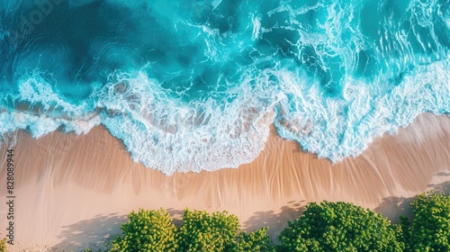 Bird's-eye view of a coastal beach, with waves crashing against the shore.