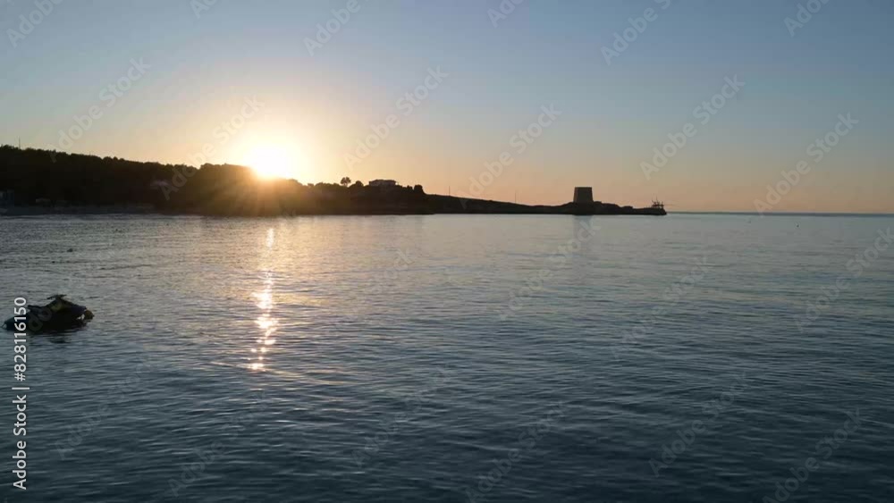 baia pugliese al tramonto con una torre saracena ed un piccolo trabucco baia pugliese al tramonto con una torre saracena ed un piccolo trabucco