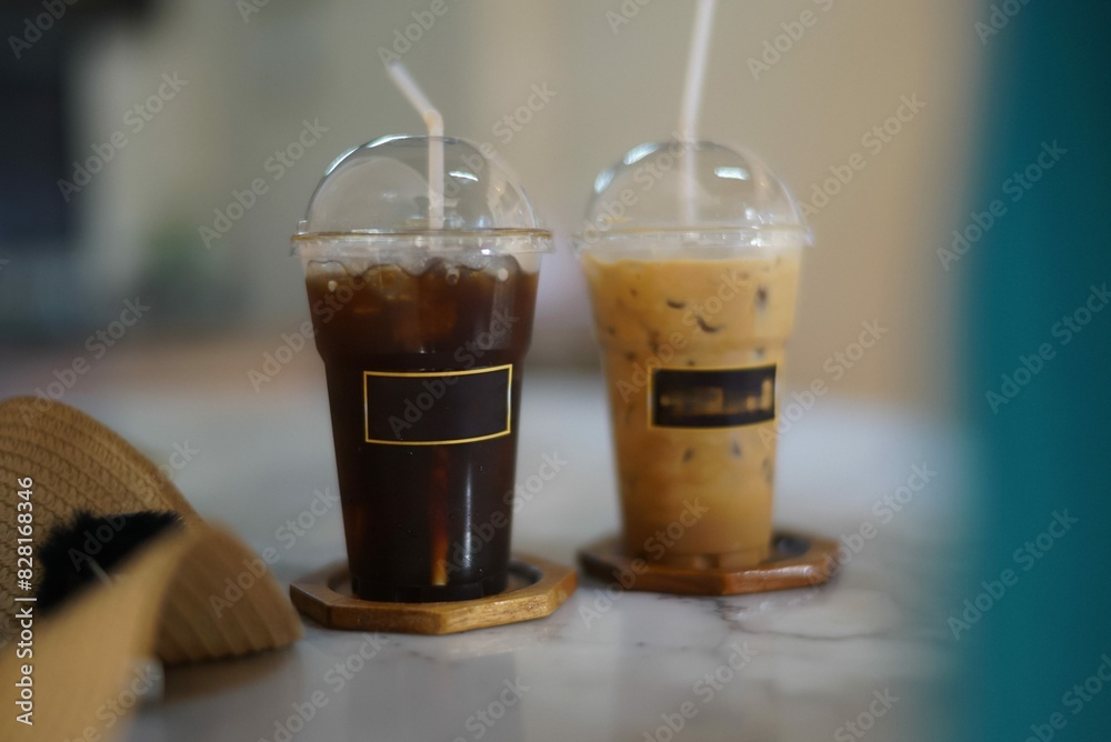 two plastic glasses of coffee on the table