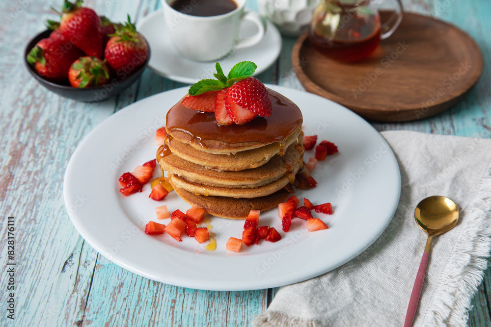 Stack of pancakes hotcakes with honey and strawberries breakfast food american style Stack of pancakes hotcakes with honey and strawberries breakfast food american style