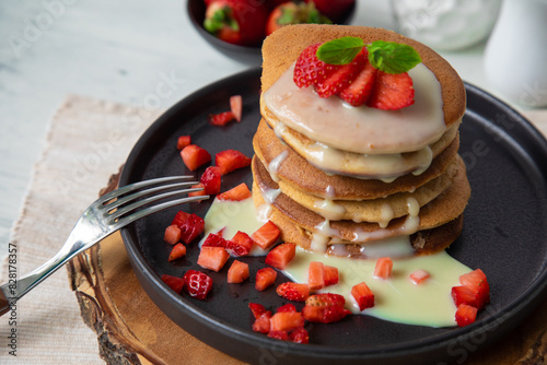 Stack of pancakes hotcakes with honey and strawberries breakfast food american style photo