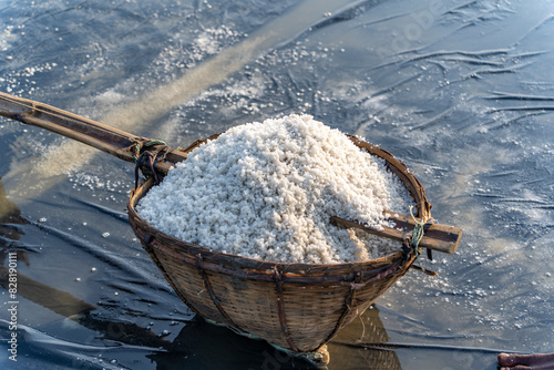 Sea salt process at rural area of Bangladesh. Raw material of salt industrial. Sodium Chloride mineral. Evaporation and crystallization of sea water. White salt harvesting. Agriculture industry. photo