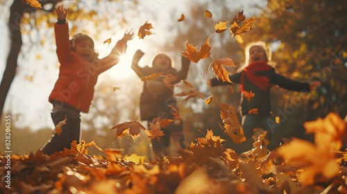 Children jumping into a pile of autumn leaves, their faces lit up with excitement and joy photo
