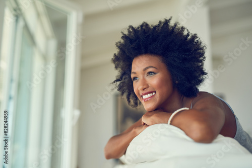 Black woman, relax and thinking on sofa in home with happiness and ideas for future. Remember, memory and girl with a smile in calm morning in living room of apartment with inspiration or positivity