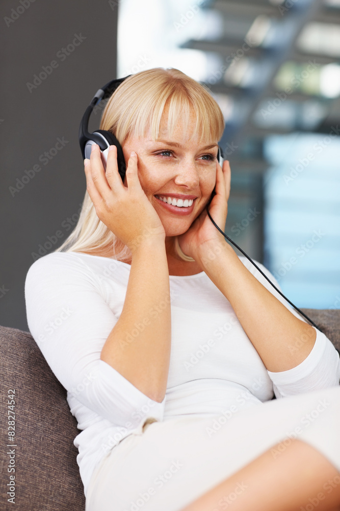 Headphones, music and smile with woman on sofa in living room of home to relax for weekend time off. Radio, streaming and thinking with happy person listening to audio playlist or sound in apartment Headphones, music and smile with woman on sofa in living room of home to relax for weekend time off. Radio, streaming and thinking with happy person listening to audio playlist or sound in apartment
