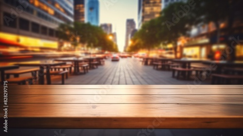 A wooden table top with blur background of street in downtown business district with people walking.
