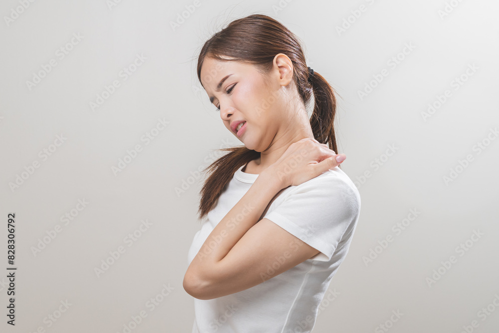 Pain body muscles stiff problem, asian young woman, girl painful with neck pain body ache from work, holding massaging rubbing shoulder hurt, sore on white background. Health care and medicine concept Pain body muscles stiff problem, asian young woman, girl painful with neck pain body ache from work, holding massaging rubbing shoulder hurt, sore on white background. Health care and medicine concept