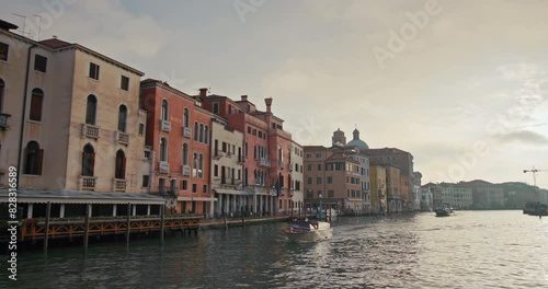 Architecture of buildings on canals in Venice, Italy. Sunset in a city urban landscape with historic buildings in a tourist town. High quality 4k footage photo