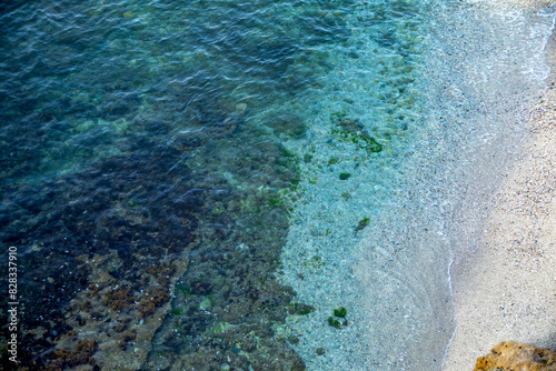 View from above of the shore of a beach with crystal clear emerald green waters in the Puntas de Calnegre regional park in the Region of Murcia, Spain photo