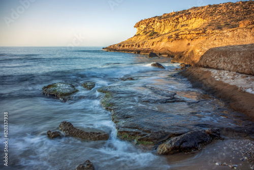 Beautiful cove in the natural regional park of Puntas de Calnegre and Cabo Cope with sunrise light in Region of Murcia, Spain photo