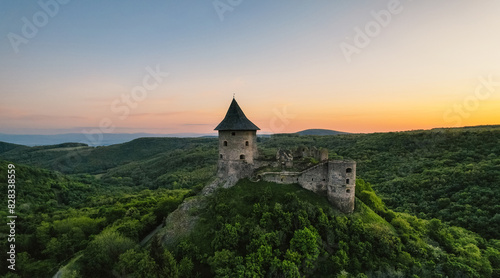 Ruins of a medieval castle Somoska or Somoskoi var. on borders of southern Slovakia and Hungary at sunrise time. photo