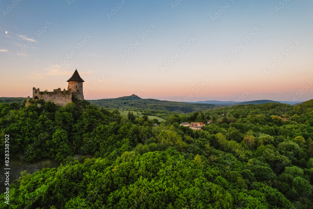 Ruins of a medieval castle Somoska or Somoskoi var on borders of southern Slovakia and Hungary at sunrise time. .Salgo Castle or Salgo vara in background Ruins of a medieval castle Somoska or Somoskoi var on borders of southern Slovakia and Hungary at sunrise time. .Salgo Castle or Salgo vara in background