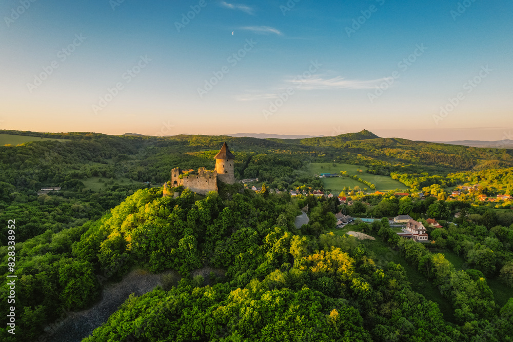 Ruins of a medieval castle Somoska or Somoskoi var on borders of southern Slovakia and Hungary at sunrise time.  .Salgo Castle or Salgo vara in background