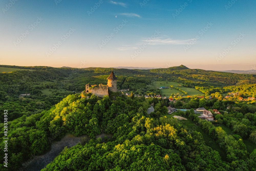 Ruins of a medieval castle Somoska or Somoskoi var on borders of southern Slovakia and Hungary at sunrise time. .Salgo Castle or Salgo vara in background Ruins of a medieval castle Somoska or Somoskoi var on borders of southern Slovakia and Hungary at sunrise time. .Salgo Castle or Salgo vara in background
