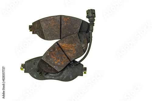 Three used brake pads on a white background.