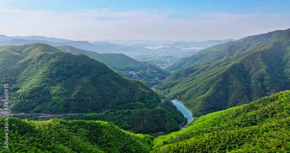 Aerial view of green forest and mountain nature landscape in summer. Curved asphalt road in valley. Aerial view of green forest and mountain nature landscape in summer. Curved asphalt road in valley.