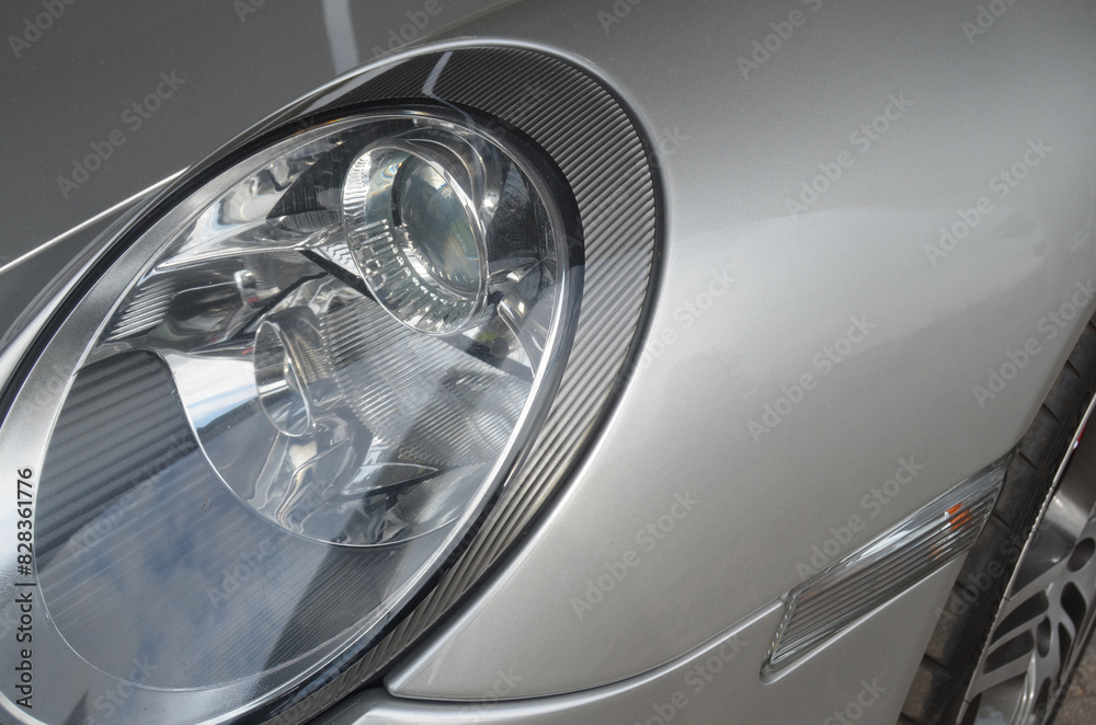 Car headlight close-up. Luxury vehicle detail of headlight. Car headlight close-up. Luxury vehicle detail of headlight.
