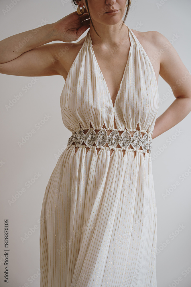 Beautiful elegant woman in pastel creamy beige evening dress. Bohemian chic fashion concept Beautiful elegant woman in pastel creamy beige evening dress. Bohemian chic fashion concept