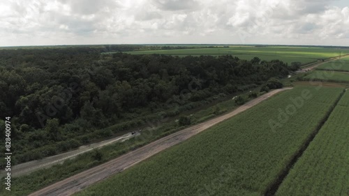 Wallpaper Mural Aerial Panning Scenic Shot Of Motorboat Moving On Rippled River Amidst Green Landscapes Under Cloudy Sky - Bayou Vista, Texas Torontodigital.ca