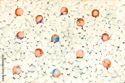 White stones glass gem orange red balls background