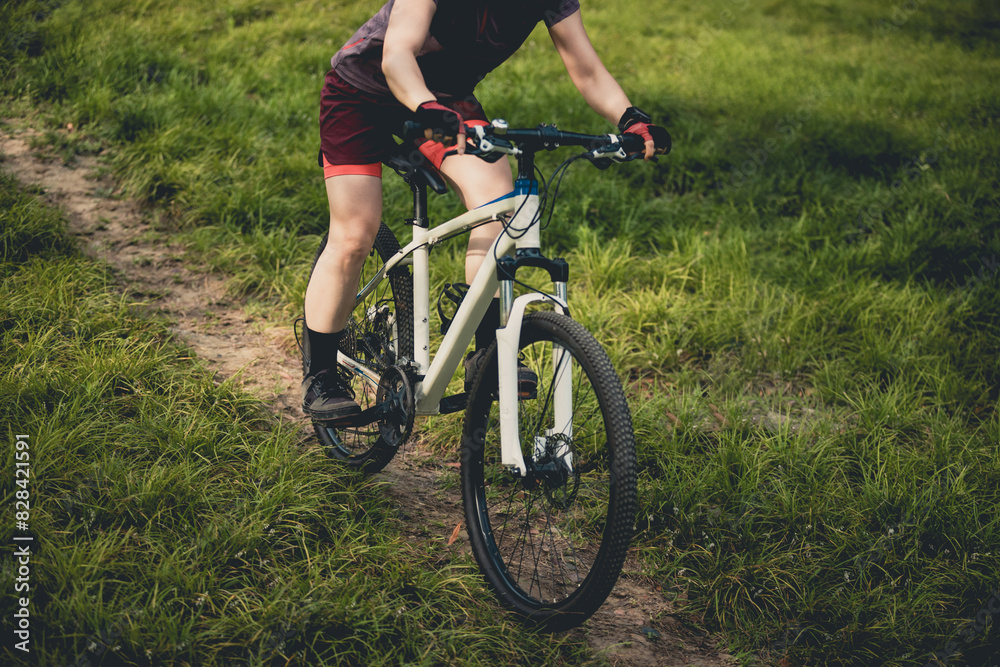 Woman mountain biking on mountain trail Woman mountain biking on mountain trail