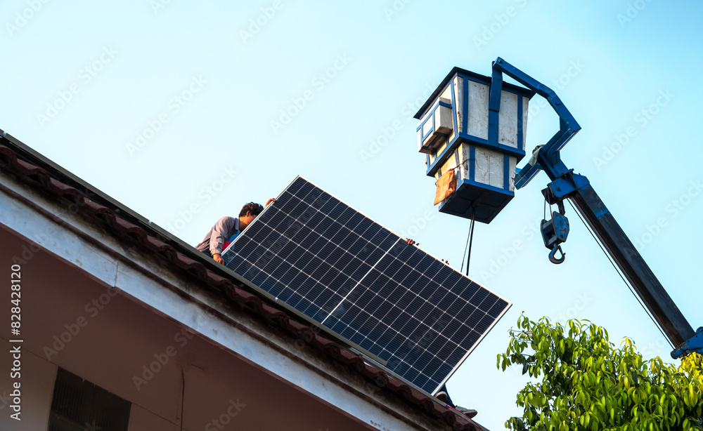 Hydraulic Boom lift bucket working with solar panel installing on high roof Hydraulic Boom lift bucket working with solar panel installing on high roof