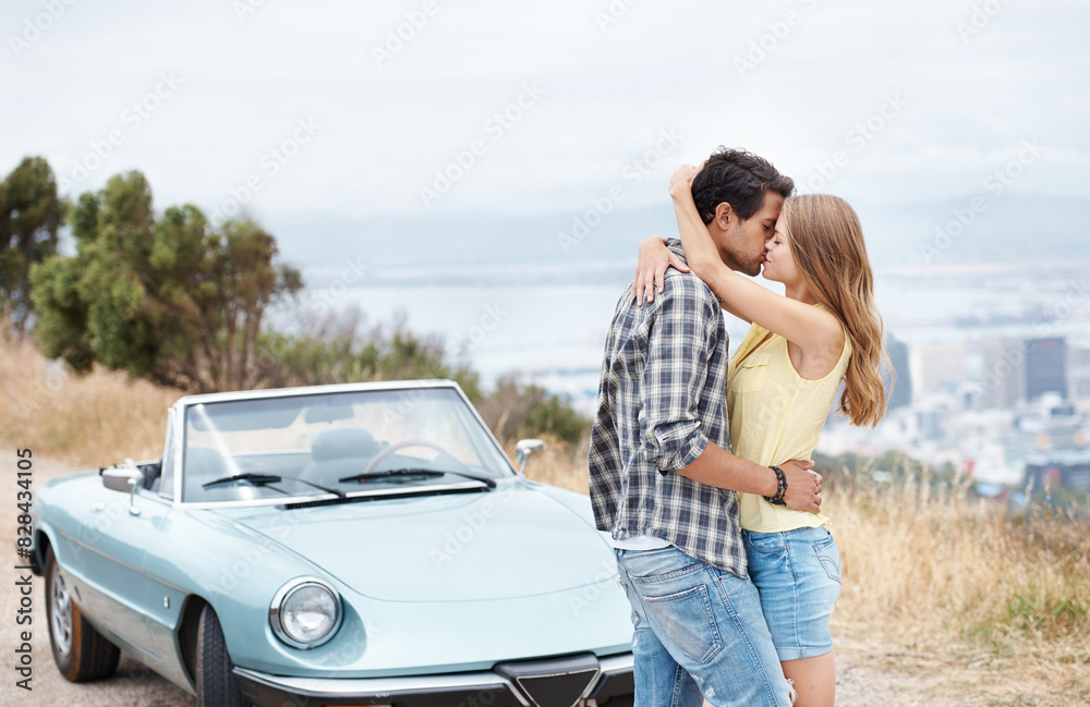 Fototapeta premium Road trip, kiss and couple in car in city on holiday, vacation and adventure for bonding, romance and love. Travel destination, dating and man and woman embrace for transport, journey and together