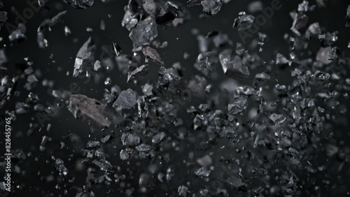 Super Slow Motion Shot of Coal Pieces Flying Up at 1000 fps. photo